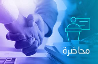 Two businessmen are shaking hands over a laptop