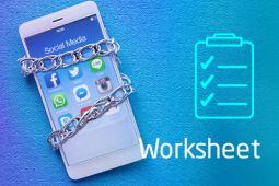 A smartphone showing social media apps on its screen is chained to signify social media addiction
