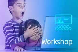 A boy is shocked and covers the eyes of a girl to protect her to from the inappropriate content on the laptop screen