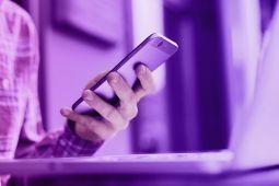 A hand of a young male using a smartphone.